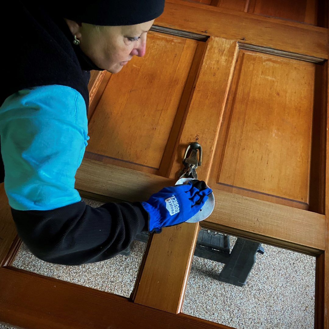 Gina sanding the front door of a homeowner on National Rebuilding Day