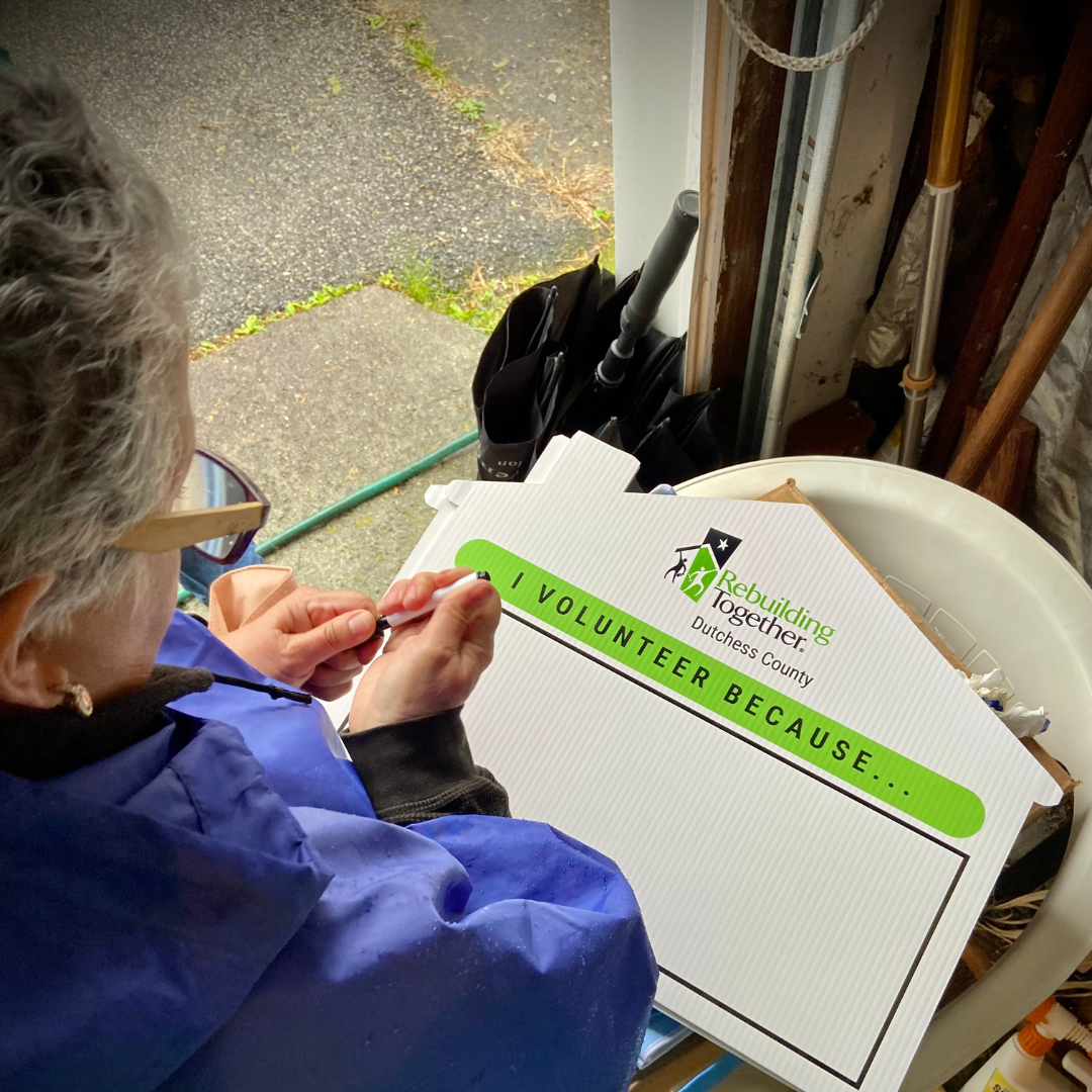 Gina writing in why she volunteers for our "Why I Volunteer" campaign