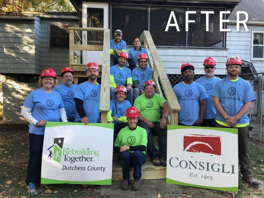 The team of volunteers pose on the back steps after they were replaced.