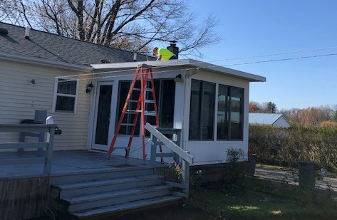 A Consigli volunteer repairing the sunroom roof