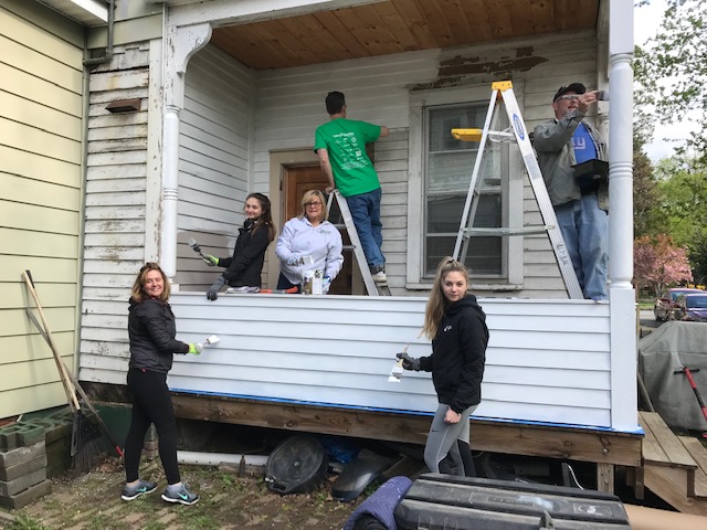 Volunteers paint the back porch of a Dutchess County resident this past April, thanks to Rebuilding Together’s Rebuilding Day program.