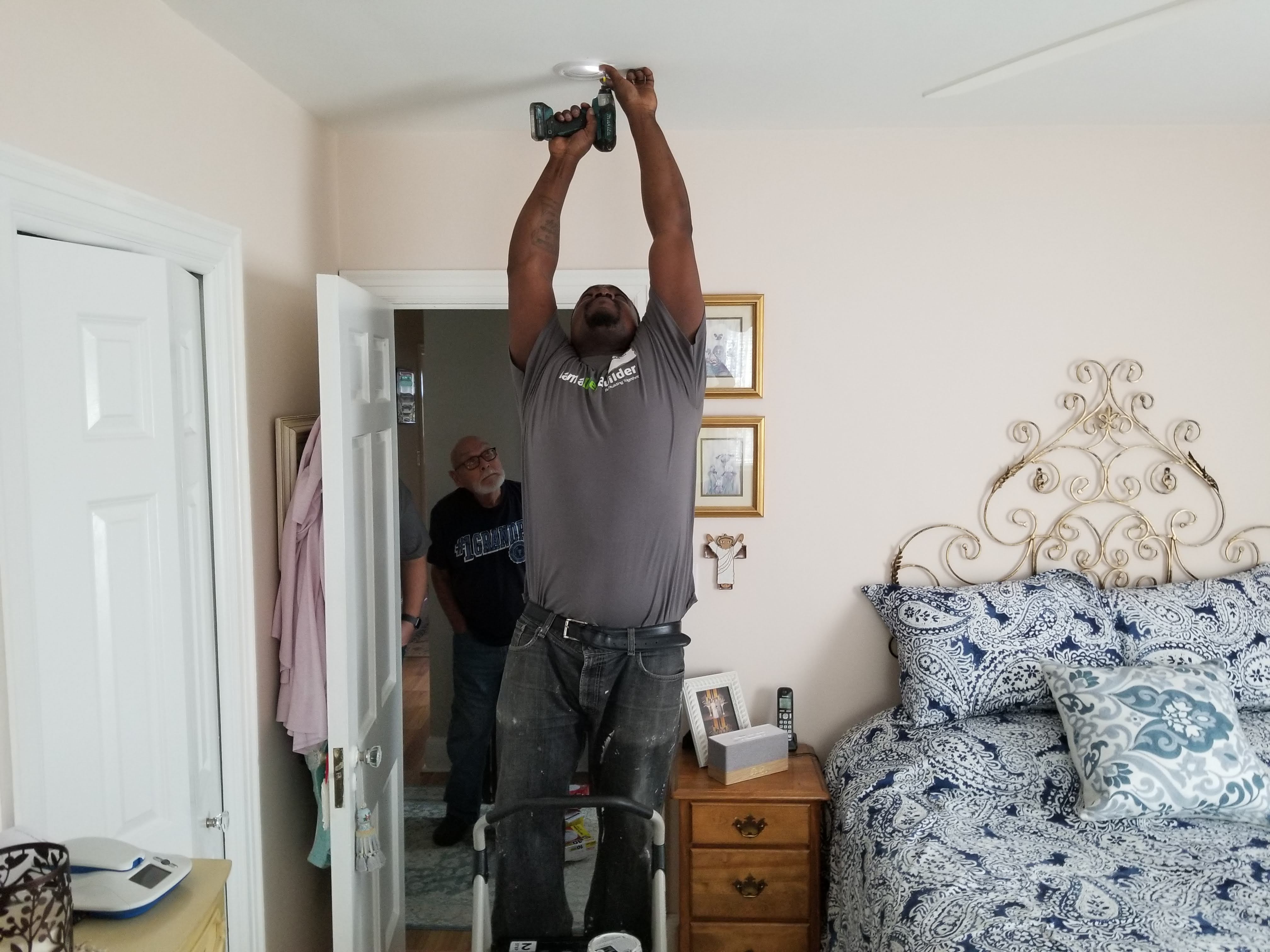 A State Farm volunteer installs a smoke alarm