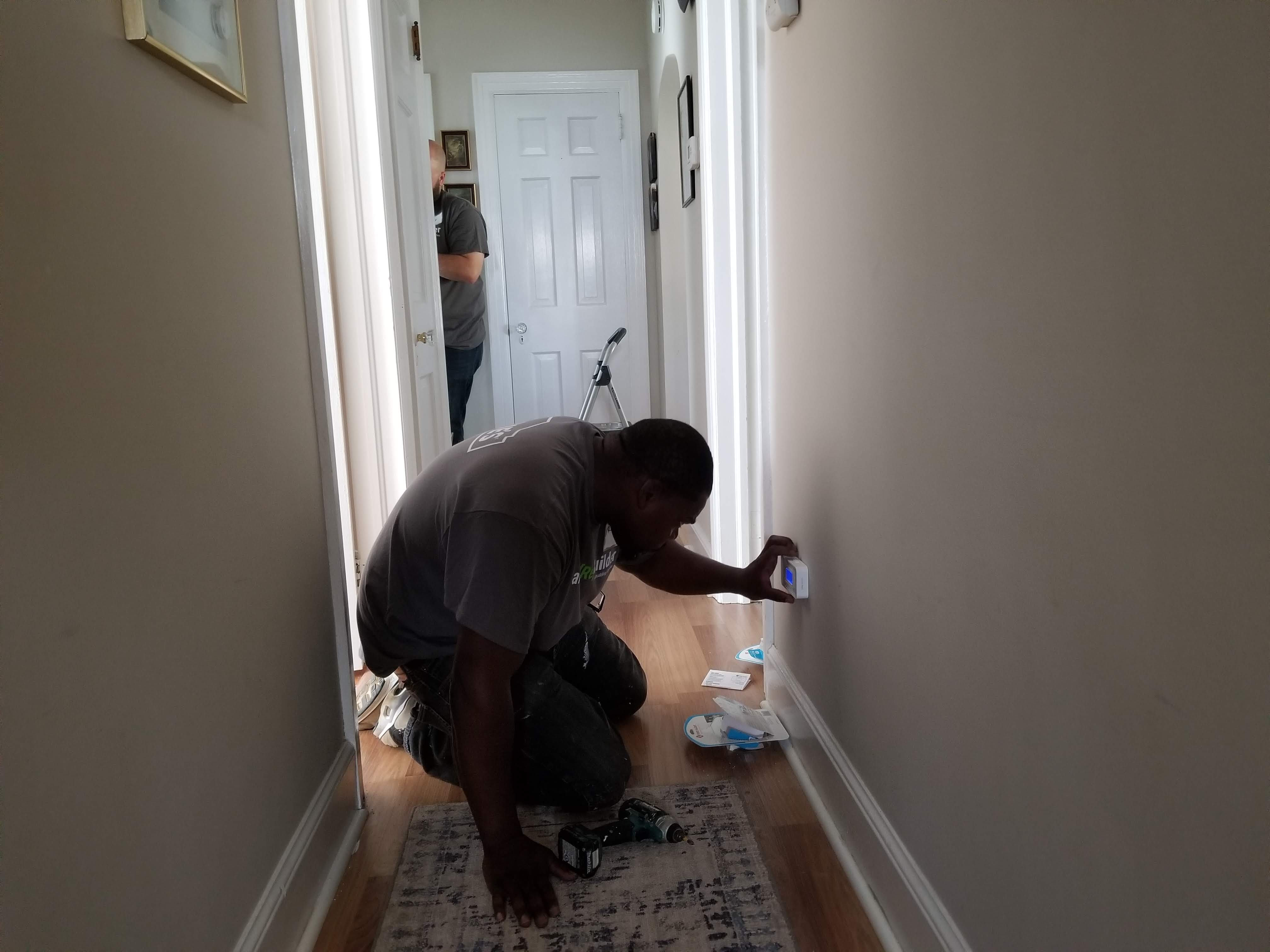 A State Farm volunteer installs a carbon monoxide alarm