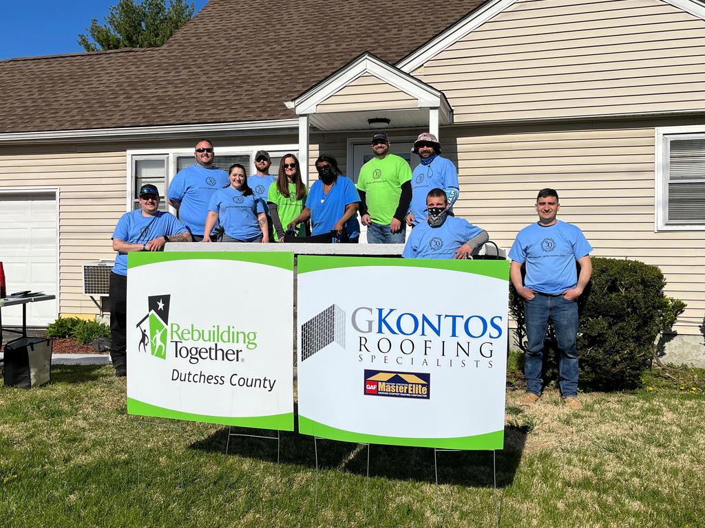 Volunteers from GKontos Roofing with homeowner Alice.