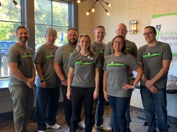 The Rebuilders & Brewers event committee members, including Chris Davino (far right), Rachel Ronk (right), and Dan Brauer (3rd from right), at the event in 2019.