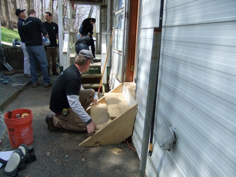 TD Bank volunteers working on a homeowner's steps