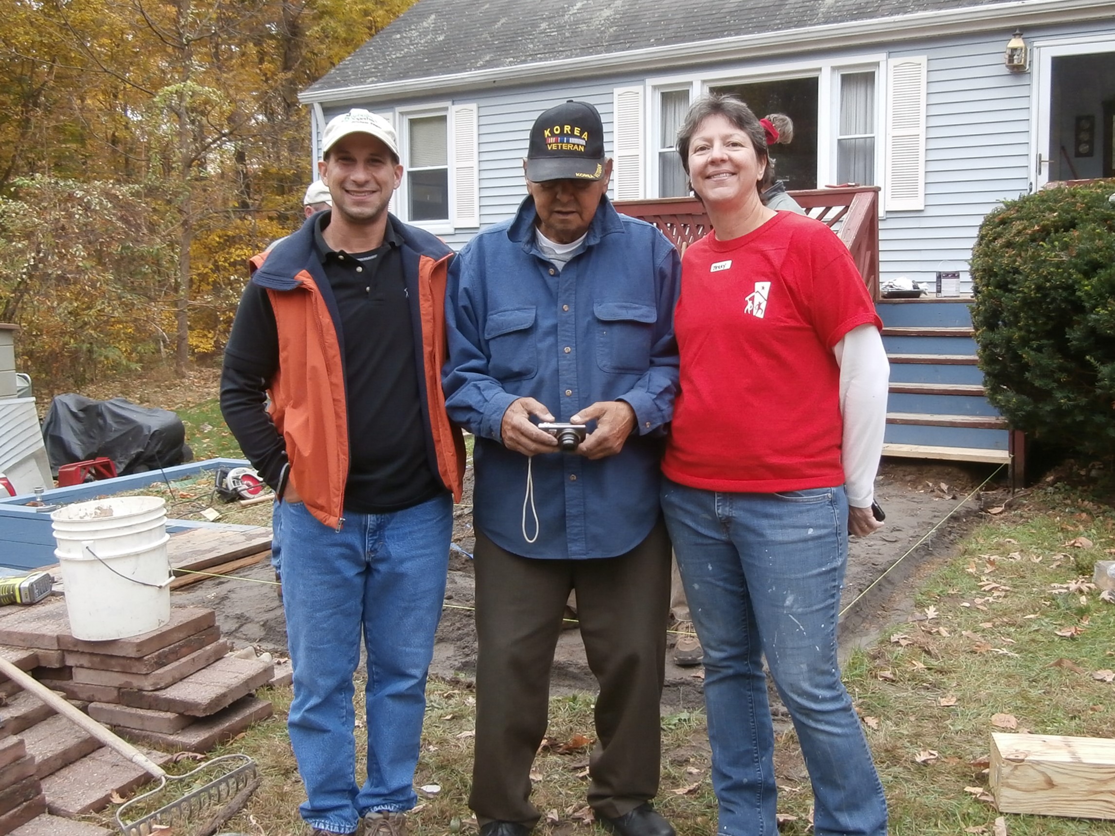 Wyeth with a homeowner and volunteer coordinator Terry Temple.